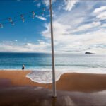 Tranquil Beach Walk With Island and Ocean View Peaceful beach walk with island view, ocean waves, golden sand, and scenic sky.