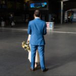 Groom in Blue Suit Awaits Bride at Train Station Bride in white gown with groom in blue suit at train station.