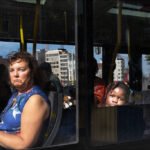 Woman and Child on City Bus Reflecting Life’s Contrasts Woman and child on city bus ride showing contrast between adult worries and childhood innocence.
