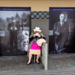 Woman Enjoying Ice Cream by Vintage Mural Elderly woman eating ice cream on bench with vintage mural background.