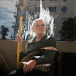 Elderly Woman Reflecting by Window on City Tram Elderly woman riding public transport in city, thoughtful expression by window.
