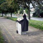 Whimsical Ghost Trash Bin Street Art on Urban Pathway Ghost trash bin street art on urban pathway with trees and whimsical cloak.
