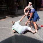 Women Struggling in Busy Outdoor Shopping Market Women arguing and struggling in busy outdoor shopping street market scene.
