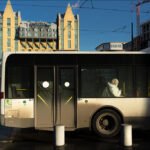 City Bus Passenger Against Radisson Blu Hotel Skyline City bus with passenger near Radisson Blu Hotel and modern urban architecture.