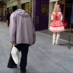Whimsical Street Fashion in a Busy City Scene Contrasting styles on a city street.