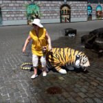 Woman Posing With Playful Tiger Sculpture on Street Woman posing with playful tiger sculpture on cobblestone street with colorful mural background.