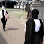 Women in Hijab Walking on European City Pathway Two women in hijabs walking