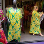 Vibrant beachwear boutique displaying colorful summer kaftans and tropical resort clothing.