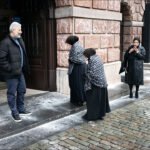 Urban street scene blending traditional clothing and modern fashion in a diverse cultural setting.